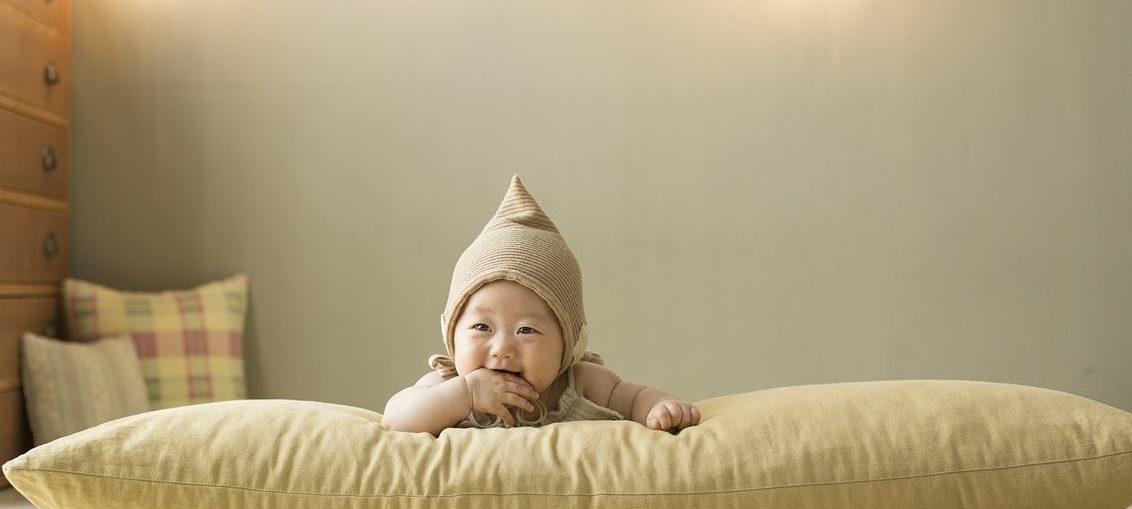 feather pillow and baby